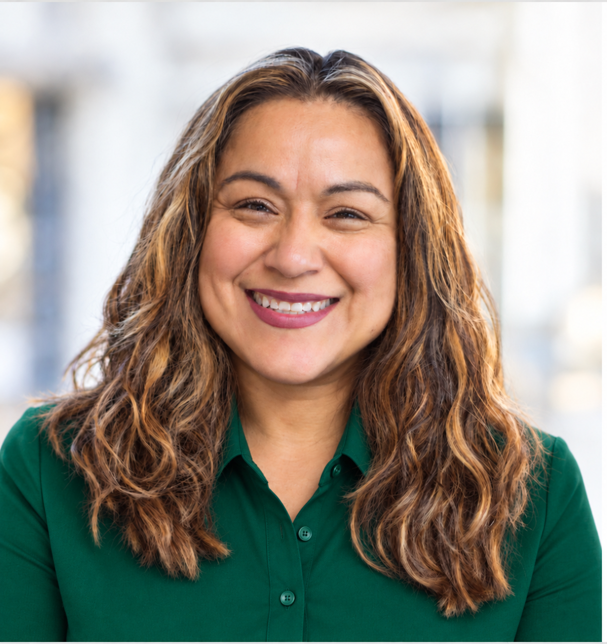 Anavelia Segura in an emerald green collared shirt, assistant in decorating, event setup and planning